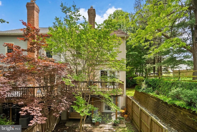 10938 Rocky Mount Way, Silver Spring, MD 20902 - view of home's exterior featuring a wooden deck, fence, and a chimney