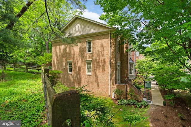 10938 Rocky Mount Way, Silver Spring, MD 20902 - view of side of home featuring fence and brick siding