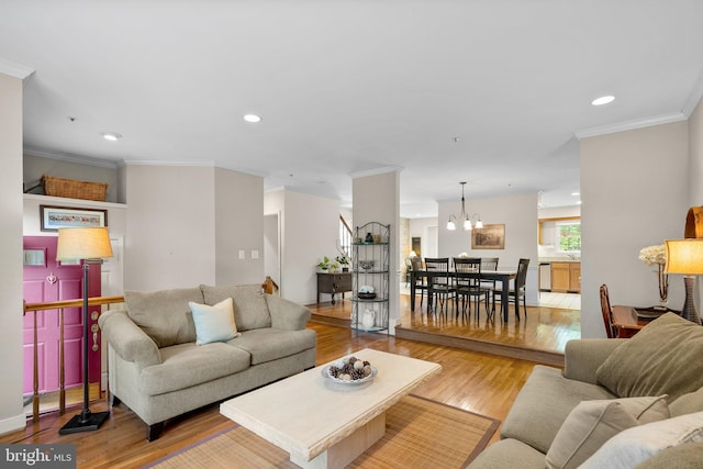 10938 Rocky Mount Way, Silver Spring, MD 20902 - living area with light wood finished floors, a chandelier, crown molding, and recessed lighting