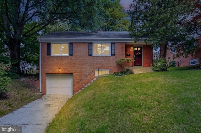 1102 Jackson Ave, Takoma Park, MD 20912 - tri-level home with an attached garage, driveway, a front yard, brick siding, and roof with shingles