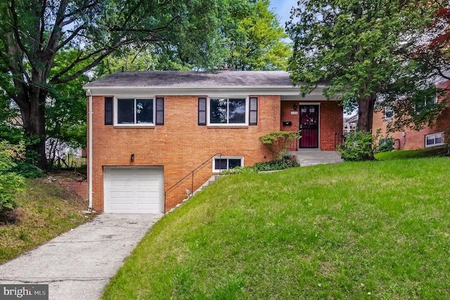 1102 Jackson Ave, Takoma Park, MD 20912 - split level home with an attached garage, driveway, a front lawn, and brick siding
