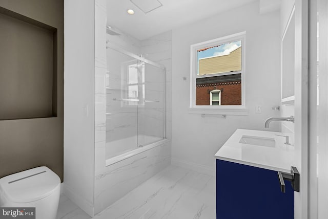1615 S 22nd St, Philadelphia, PA 19145 - bathroom with marble look tiles, baseboards, toilet, double vanity, and combined bath / shower with glass door