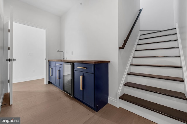 1615 S 22nd St, Philadelphia, PA 19145 - indoor wet bar with light wood-type flooring, stairs, baseboards, and beverage cooler
