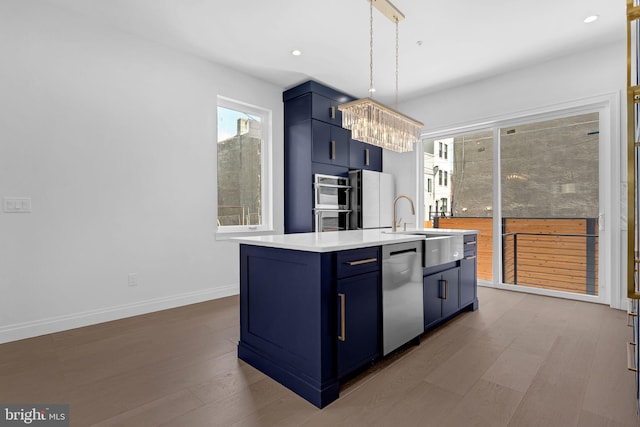 1615 S 22nd St, Philadelphia, PA 19145 - kitchen featuring blue cabinetry, dishwasher, a chandelier, a center island with sink, and baseboards