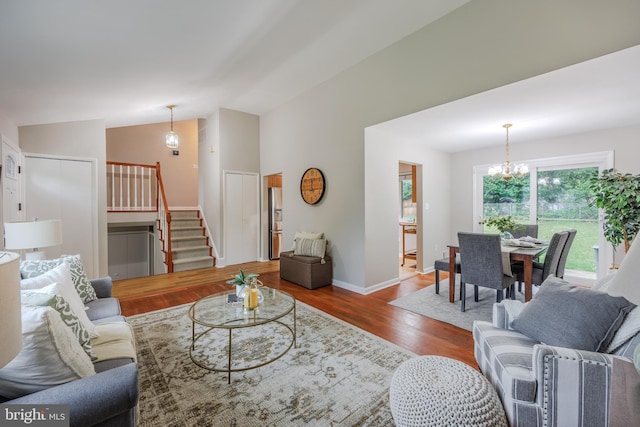 808 Gregorio Dr, Silver Spring, MD 20901 - living area with stairway, a chandelier, wood finished floors, lofted ceiling, and baseboards