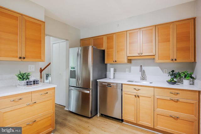 808 Gregorio Dr, Silver Spring, MD 20901 - kitchen featuring appliances with stainless steel finishes, a sink, light wood-style flooring, light countertops, and light brown cabinetry