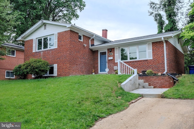 808 Gregorio Dr, Silver Spring, MD 20901 - split level home featuring a chimney, a front yard, and brick siding