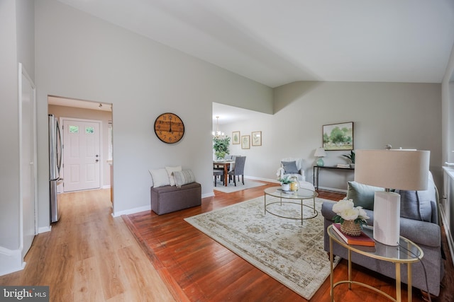 808 Gregorio Dr, Silver Spring, MD 20901 - living area with lofted ceiling, wood finished floors, and baseboards