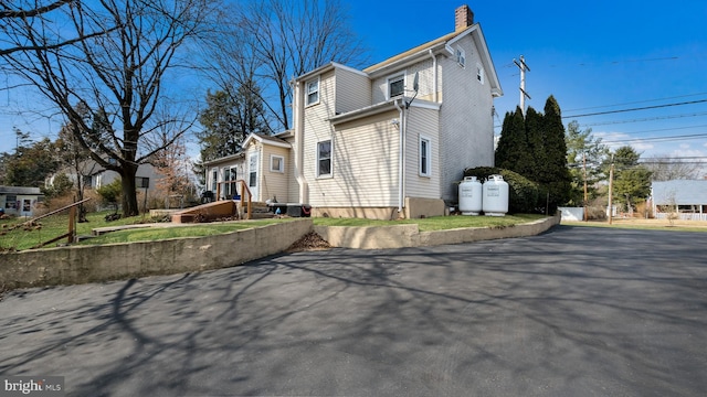 view of property exterior featuring a chimney