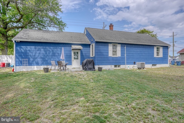 1937 Milford Harrington Hwy, Milford, DE 19963 - back of house featuring a chimney, a yard, a patio, and a shingled roof
