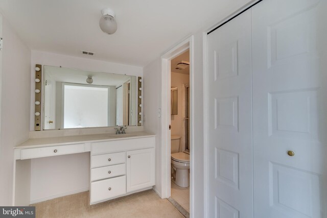 10300 Bushman Dr Unit 209, Oakton, VA 22124 - bathroom featuring toilet, vanity, and an enclosed shower