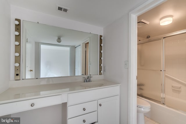 10300 Bushman Dr Unit 209, Oakton, VA 22124 - bathroom with toilet, vanity, shower / bath combination with glass door, and tile patterned flooring