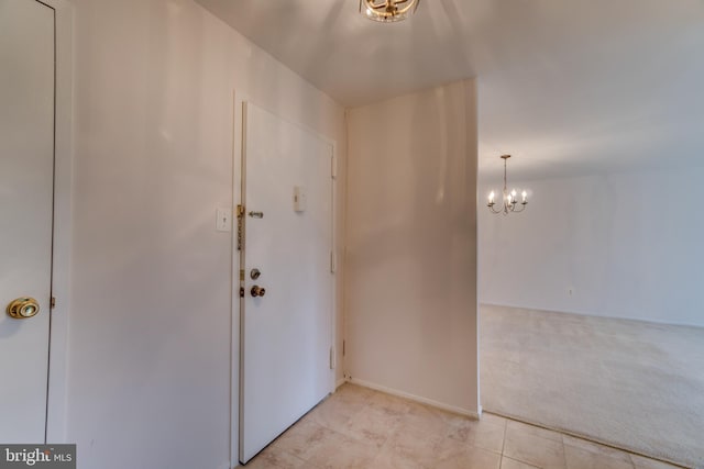 10300 Bushman Dr Unit 209, Oakton, VA 22124 - foyer featuring light carpet, a chandelier, and light tile patterned floors