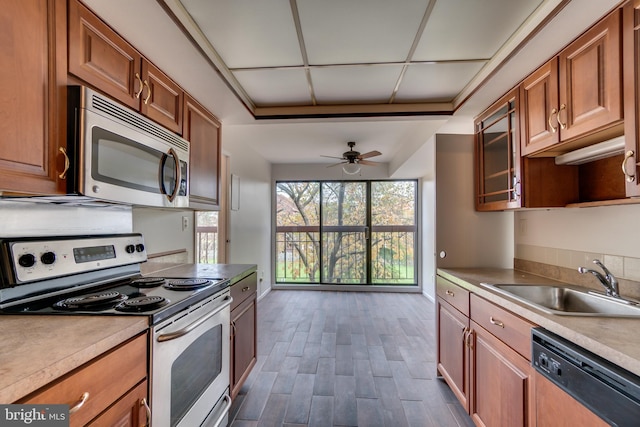 10300 Bushman Dr Unit 209, Oakton, VA 22124 - kitchen with stainless steel appliances, a sink, dark wood finished floors, and brown cabinets