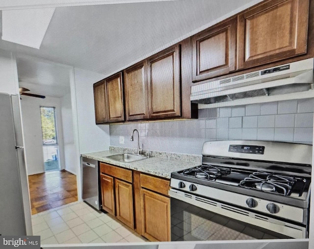 7212 Donnell Pl Unit B-5, District Heights, MD 20747 - kitchen with range with gas stovetop, dishwasher, freestanding refrigerator, decorative backsplash, and under cabinet range hood