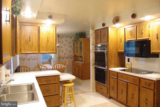 13920 Heavenly Acres Rdg, Hancock, MD 21750 - kitchen featuring black appliances, a sink, wallpapered walls, a kitchen breakfast bar, and light countertops