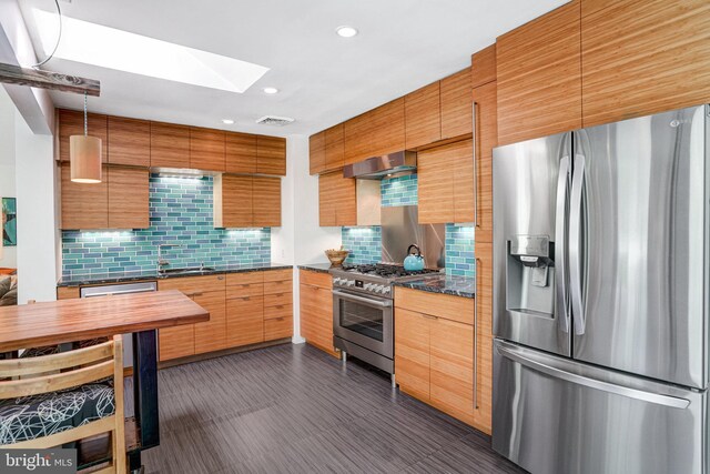 1937 Marthas Rd, Alexandria, VA 22307 - kitchen with appliances with stainless steel finishes, a skylight, decorative backsplash, wall chimney range hood, and recessed lighting