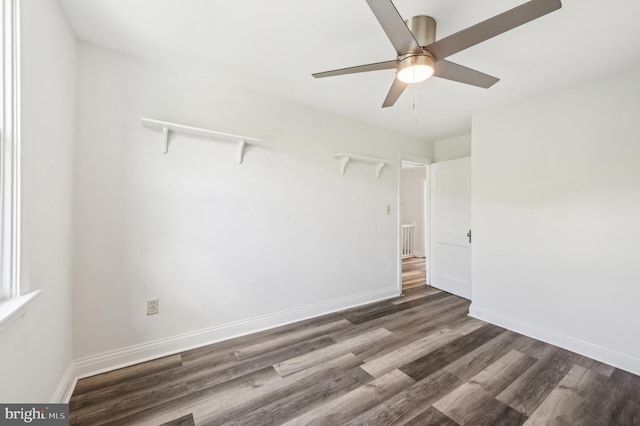 unfurnished room featuring wood finished floors, ceiling fan, and baseboards