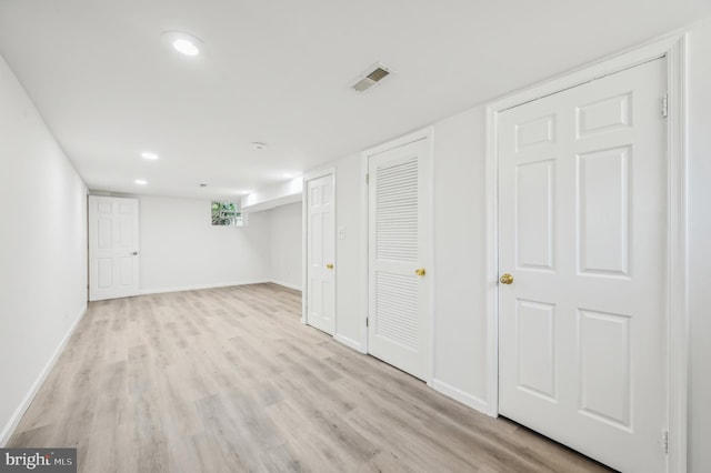 below grade area featuring light wood-style flooring, baseboards, and recessed lighting