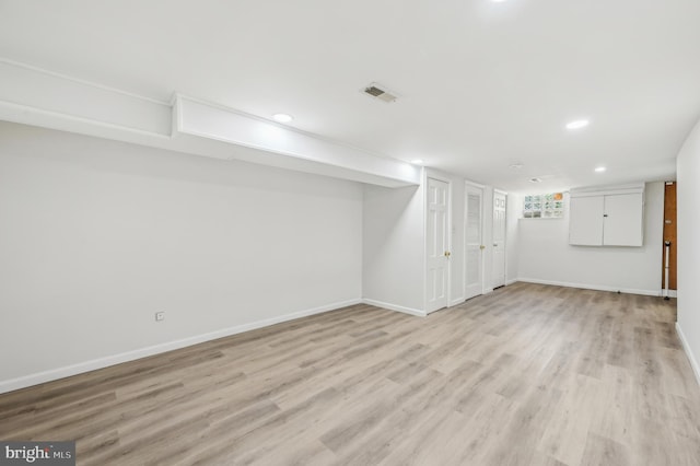 basement with light wood-type flooring, baseboards, and recessed lighting