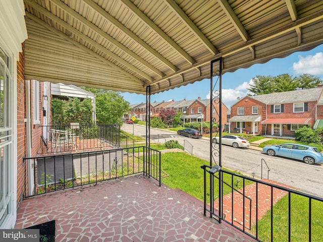 view of patio with covered porch and a residential view
