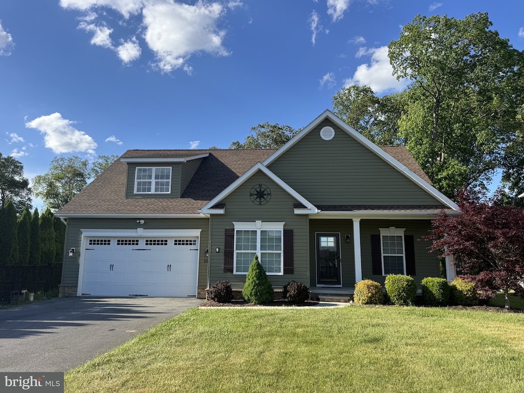 186 River Cliff Cir, Felton, DE 19943 - view of front of house with asphalt driveway, roof with shingles, a front yard, a porch, and an attached garage