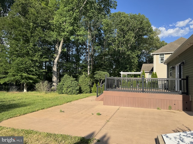 view of patio featuring a deck and view of wooded area