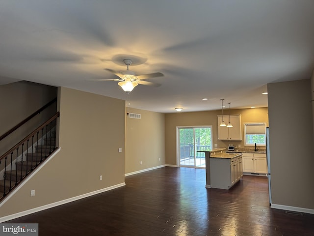 kitchen with white cabinets, dark wood-style floors, a sink, baseboards, and recessed lighting