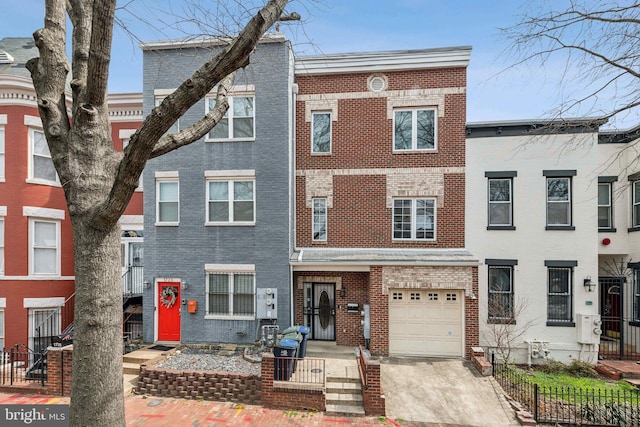 view of front of house featuring brick siding, driveway, an attached garage, and fence