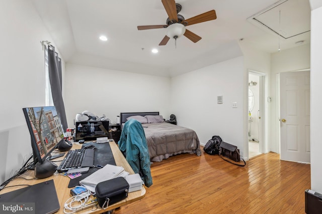 bedroom featuring attic access, light wood-style floors, an office area, recessed lighting, and ceiling fan