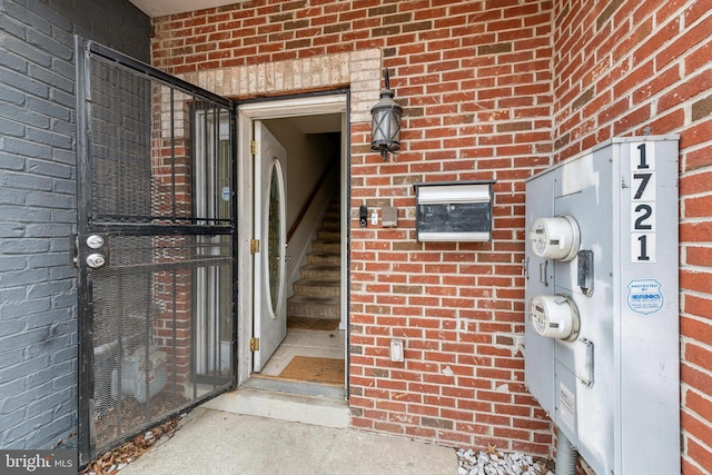 property entrance featuring brick siding