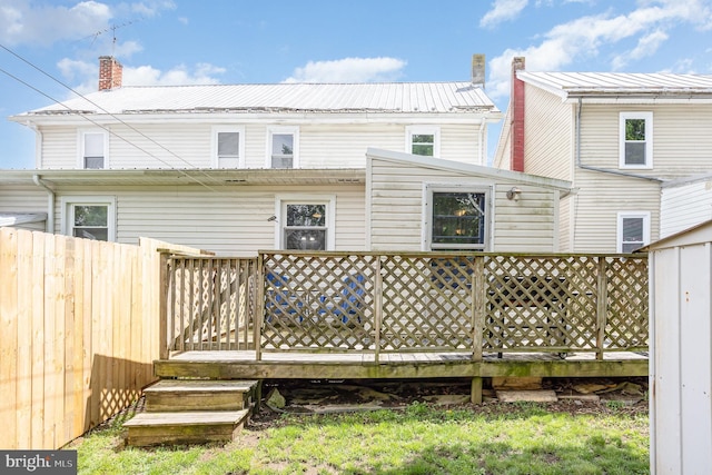 108 Fairfield St, Newville, PA 17241 - back of property with a deck, fence, a chimney, and metal roof