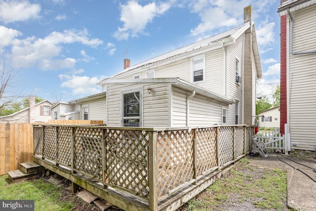 108 Fairfield St, Newville, PA 17241 - back of property featuring a deck, a chimney, fence, and metal roof