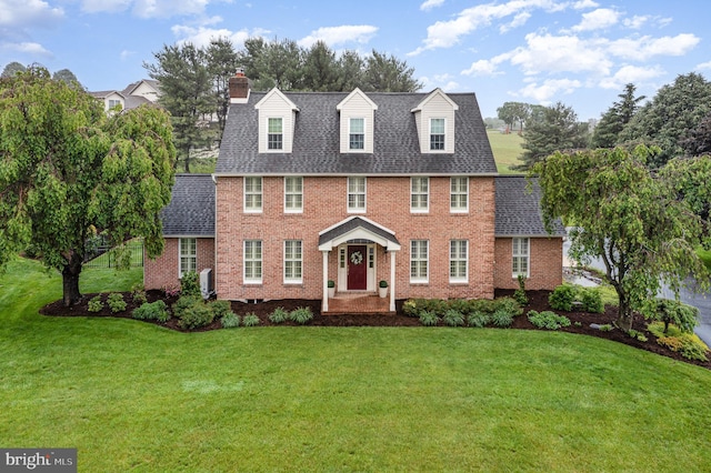 10 Highland Dr, Palmyra, PA 17078 - view of front facade featuring brick siding, a front yard, and a chimney