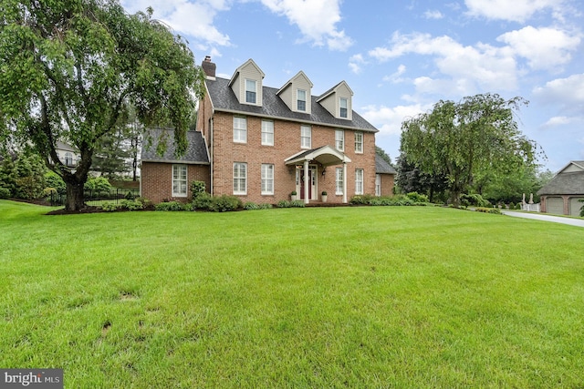 10 Highland Dr, Palmyra, PA 17078 - view of front of home featuring brick siding, a front lawn, and a chimney