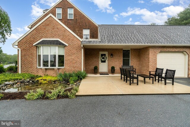 10 Highland Dr, Palmyra, PA 17078 - view of front of home with an attached garage, roof with shingles, and brick siding