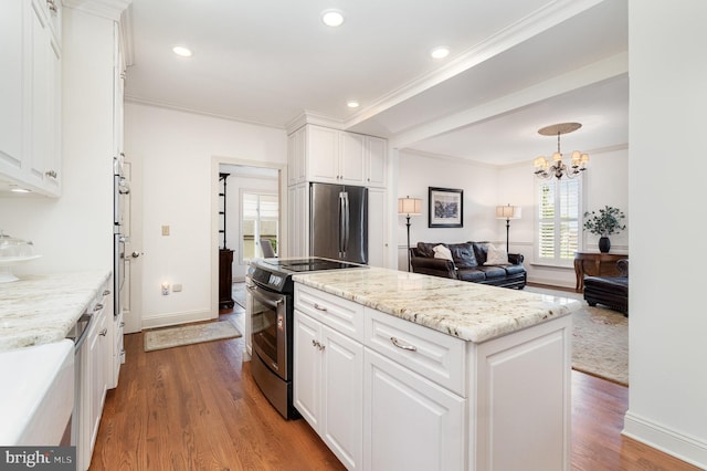 10 Highland Dr, Palmyra, PA 17078 - kitchen with stainless steel appliances, a kitchen island, dark wood-style floors, white cabinetry, and crown molding