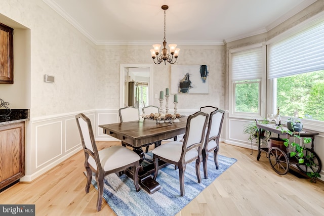 20932 Cox Mills Ct, Ashburn, VA 20147 - dining space featuring healthy amount of natural light, a chandelier, light wood-type flooring, crown molding, and a decorative wall