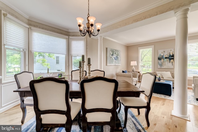 20932 Cox Mills Ct, Ashburn, VA 20147 - dining space featuring light wood-type flooring, healthy amount of natural light, a chandelier, ornamental molding, and ornate columns