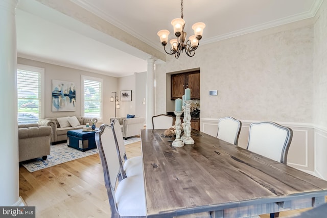 20932 Cox Mills Ct, Ashburn, VA 20147 - dining area with decorative columns, crown molding, light wood-type flooring, and a chandelier