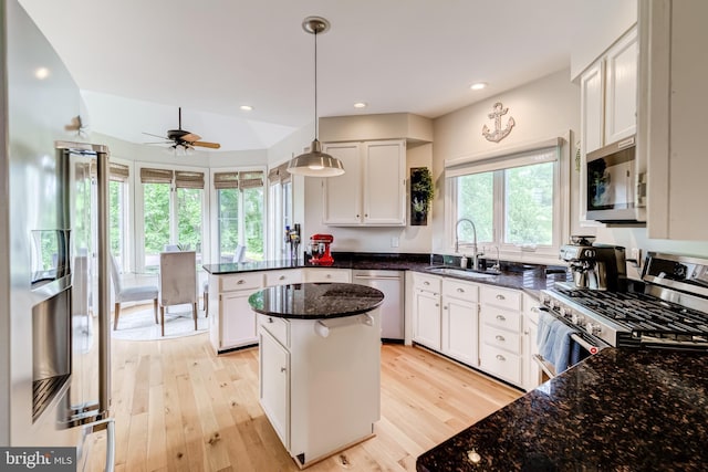 20932 Cox Mills Ct, Ashburn, VA 20147 - kitchen featuring stainless steel appliances, white cabinets, light wood-type flooring, dark stone countertops, and recessed lighting
