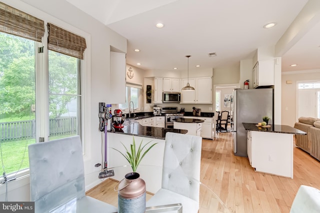 20932 Cox Mills Ct, Ashburn, VA 20147 - kitchen featuring appliances with stainless steel finishes, a peninsula, white cabinets, light wood-style flooring, and recessed lighting