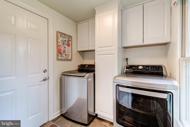20932 Cox Mills Ct, Ashburn, VA 20147 - washroom featuring washer and dryer, cabinet space, and light tile patterned flooring