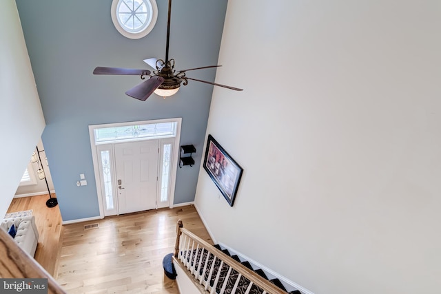 20932 Cox Mills Ct, Ashburn, VA 20147 - entrance foyer featuring a towering ceiling, a ceiling fan, light wood-style floors, and stairs