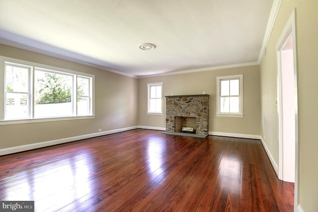 unfurnished living room featuring dark wood-style floors, crown molding, a stone fireplace, and baseboards
