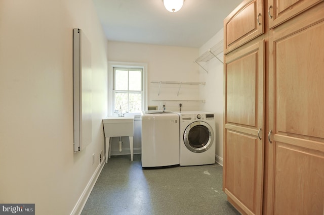 laundry room featuring baseboards, separate washer and dryer, tile patterned floors, and cabinet space