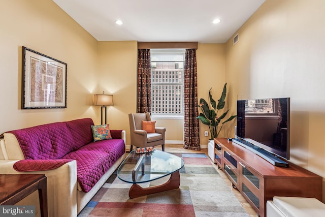 living area featuring wood finished floors, recessed lighting, and baseboards