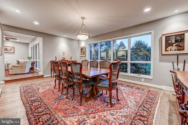 dining space with light wood-style floors, recessed lighting, and baseboards