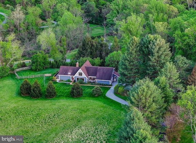 view of subject property featuring a forest