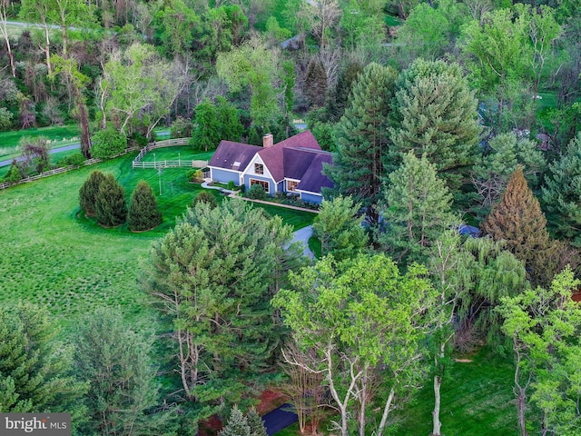 view from above of property featuring a heavily wooded area